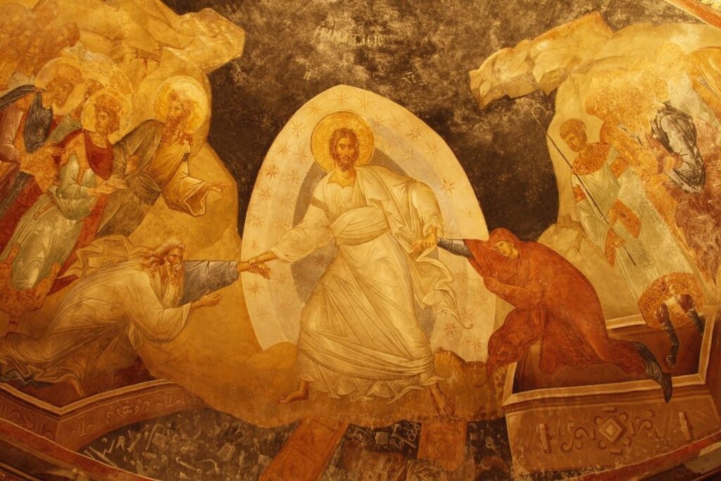 Byzantine fresco of the Resurrection: radiant Christ stands central, raising figures from darkness amid angels, saints, and golden robes.